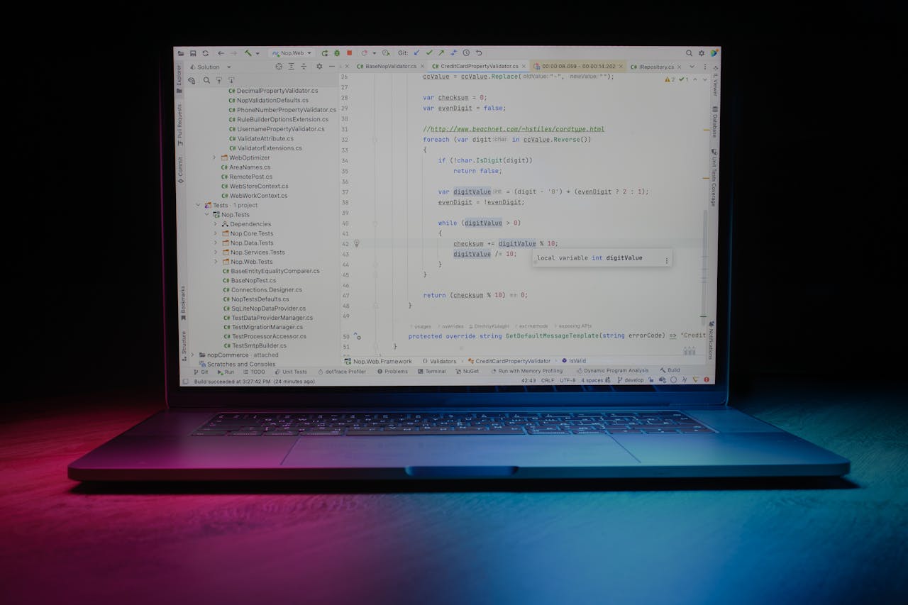 hero-img-01 Close-up of a laptop showing code editor under vibrant lighting, ideal for tech themes.